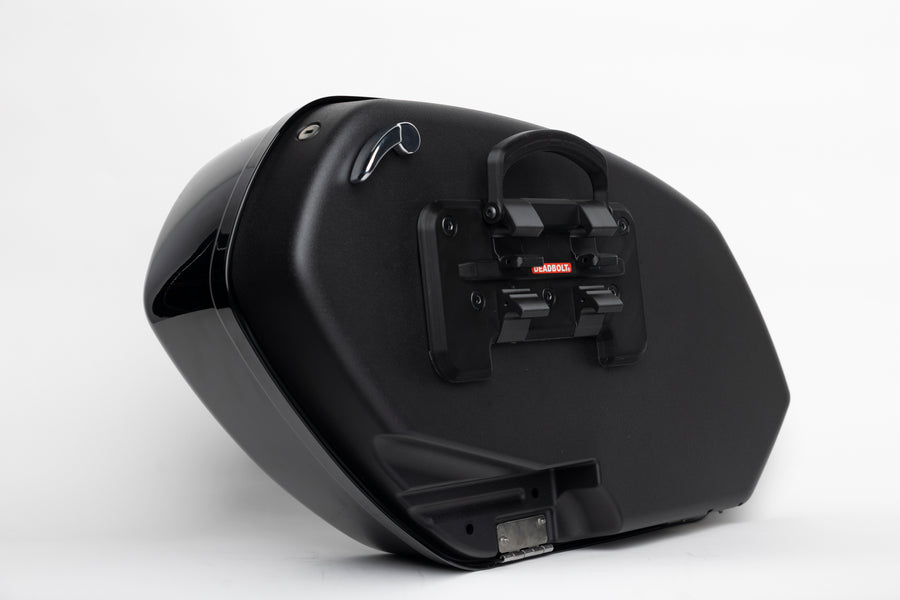 Deadbolt drop-in adapter fitted to the back of an OEM clam shell saddlebag